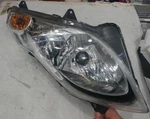 2007 Suzuki Burgman 400 Right Side Headlight Assembly. Fixed Price $225.00.