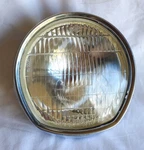 1972 Suzuki GT380- 6.5" Headlamp Assembly 12V35/25W-KOITO #110-32776/35100-33610. Fixed Price $225.00.